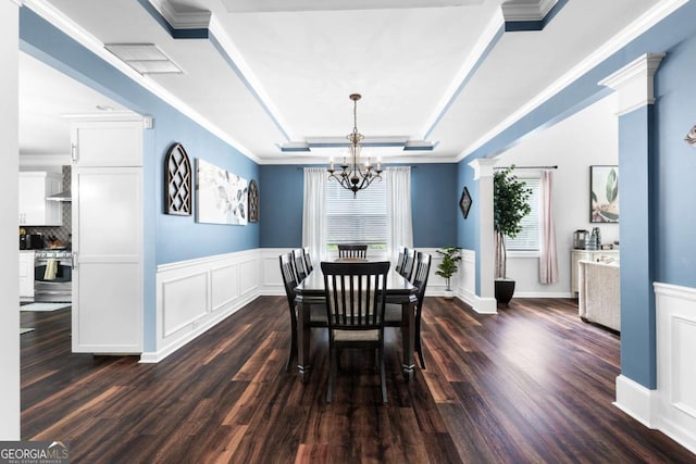 3016 Levinshire Way, Dacula, GA 30019 - dining area featuring a decorative wall, a wainscoted wall, dark wood-style flooring, a tray ceiling, and a notable chandelier