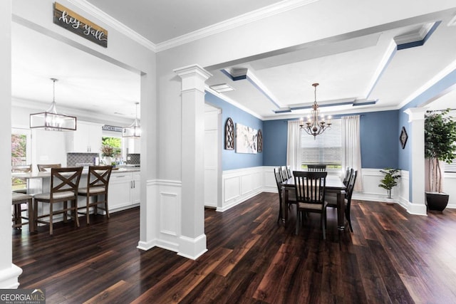3016 Levinshire Way, Dacula, GA 30019 - dining area featuring a raised ceiling, a chandelier, a wainscoted wall, and dark wood-type flooring