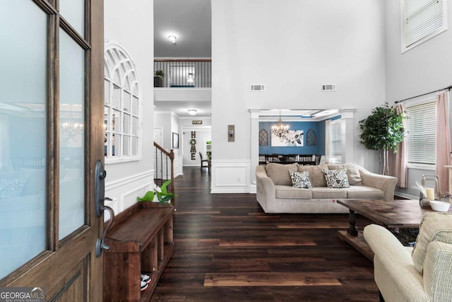 3016 Levinshire Way, Dacula, GA 30019 - living room with dark wood finished floors, visible vents, a high ceiling, and a notable chandelier