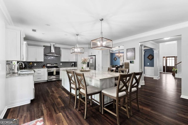 3016 Levinshire Way, Dacula, GA 30019 - kitchen with a sink, stainless steel appliances, wall chimney exhaust hood, an inviting chandelier, and backsplash