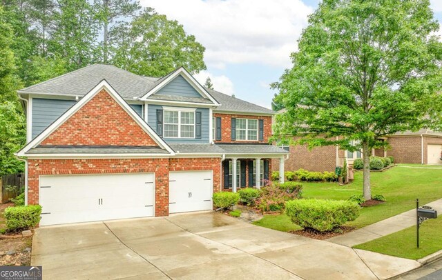 3016 Levinshire Way, Dacula, GA 30019 - view of front facade featuring concrete driveway, brick siding, roof with shingles, and a front lawn