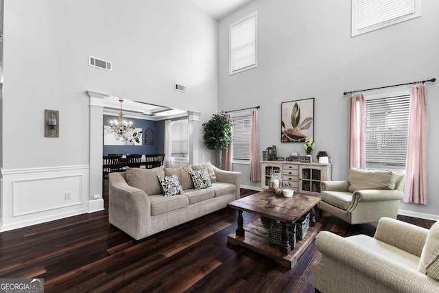 3016 Levinshire Way, Dacula, GA 30019 - living area with a chandelier, wood finished floors, visible vents, and a high ceiling