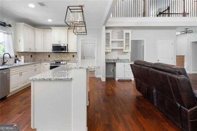 42 Treemont Dr SE, Cartersville, GA 30121 - kitchen featuring stainless steel appliances, open shelves, ornamental molding, a chandelier, and open floor plan