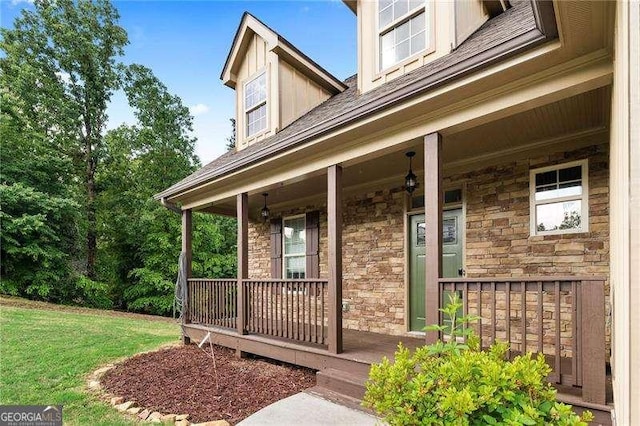 42 Treemont Dr SE, Cartersville, GA 30121 - entrance to property featuring a porch, stone siding, a lawn, board and batten siding, and a shingled roof