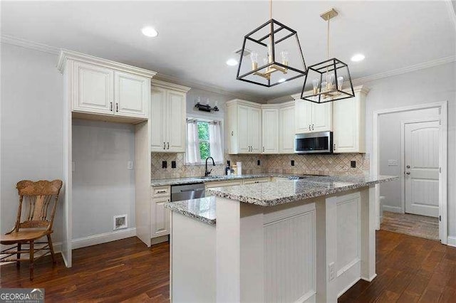 42 Treemont Dr SE, Cartersville, GA 30121 - kitchen featuring stainless steel appliances, crown molding, dark wood-style flooring, decorative backsplash, and light stone counters