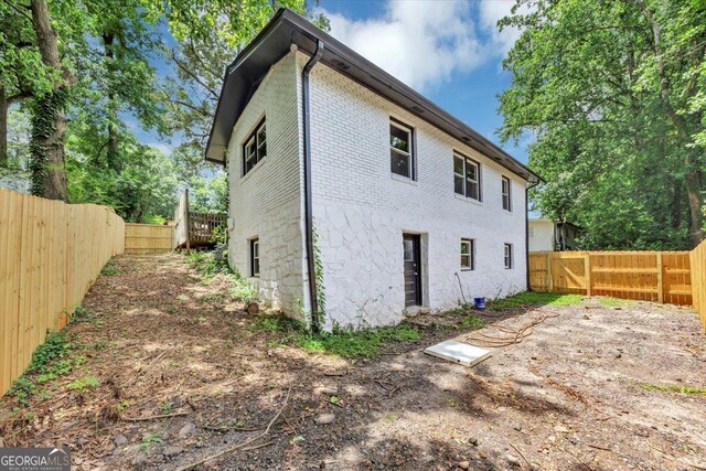 3807 Greenhill Dr, Chamblee, GA 30341 - back of property with a fenced backyard and brick siding