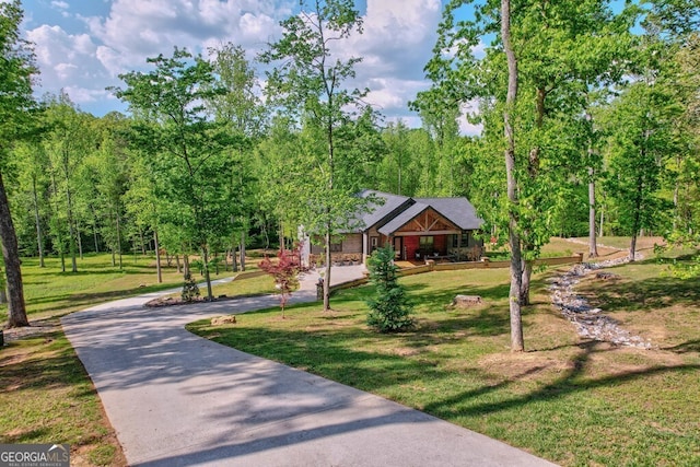surrounding community featuring a yard and driveway