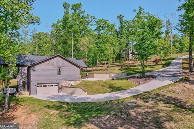 exterior space featuring a yard, driveway, and a garage