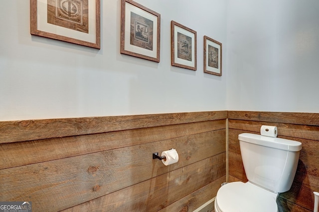 bathroom with toilet and wainscoting