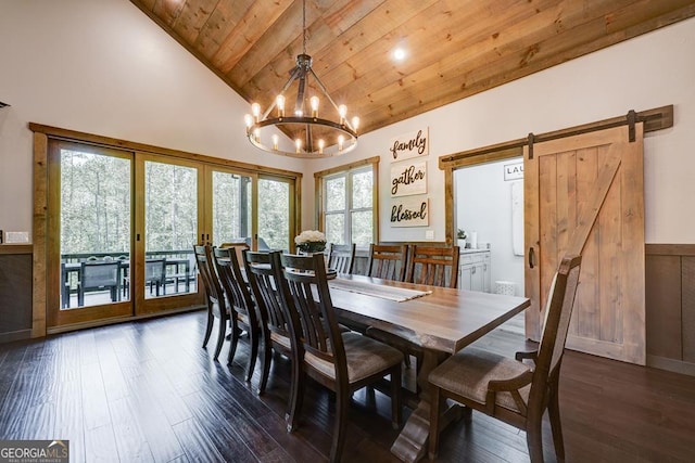 dining area with a notable chandelier, a barn door, wooden ceiling, and dark wood-type flooring