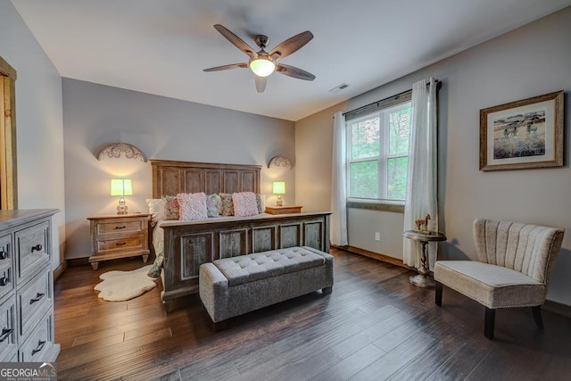 bedroom featuring baseboards, visible vents, a ceiling fan, and dark wood-type flooring