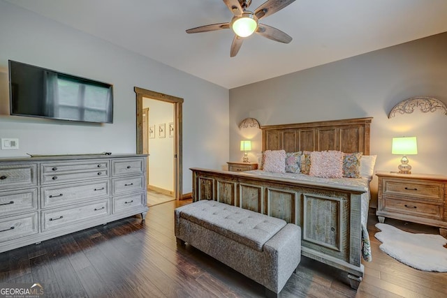 bedroom with ceiling fan, ensuite bathroom, and dark wood-style floors