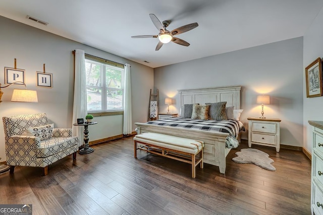 bedroom with baseboards, visible vents, a ceiling fan, and wood finished floors