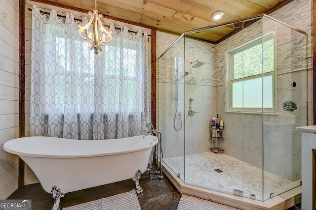 full bath featuring an inviting chandelier, wood ceiling, tile walls, a shower stall, and a freestanding tub