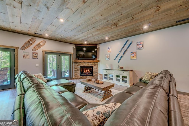 living area with french doors, a fireplace, wooden ceiling, and wood finished floors