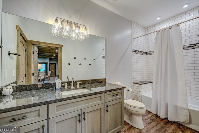 full bathroom featuring vanity, toilet, shower / bathtub combination with curtain, and wood finished floors