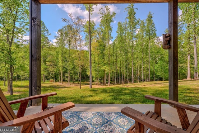exterior space featuring a view of trees and a patio
