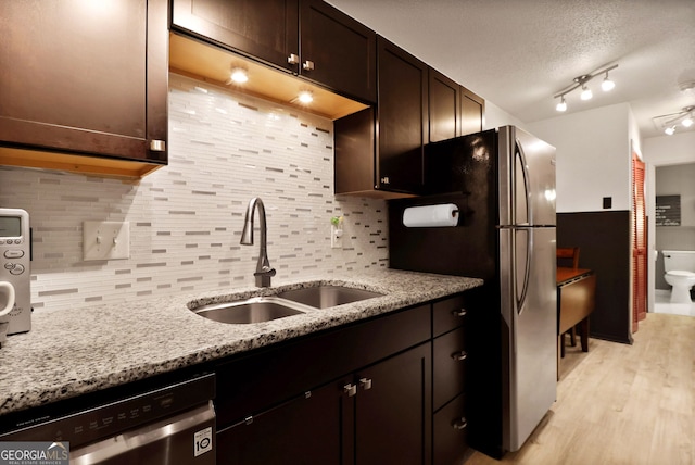 401 N Cromwell Rd Unit 6K, Savannah, GA 31410 - kitchen featuring light wood-style flooring, a sink, stainless steel appliances, dark brown cabinetry, and decorative backsplash