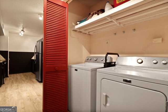 401 N Cromwell Rd Unit 6K, Savannah, GA 31410 - clothes washing area with light wood finished floors, separate washer and dryer, and track lighting