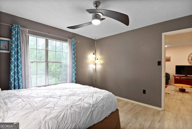 401 N Cromwell Rd Unit 6K, Savannah, GA 31410 - bedroom with baseboards, light wood-type flooring, and a ceiling fan