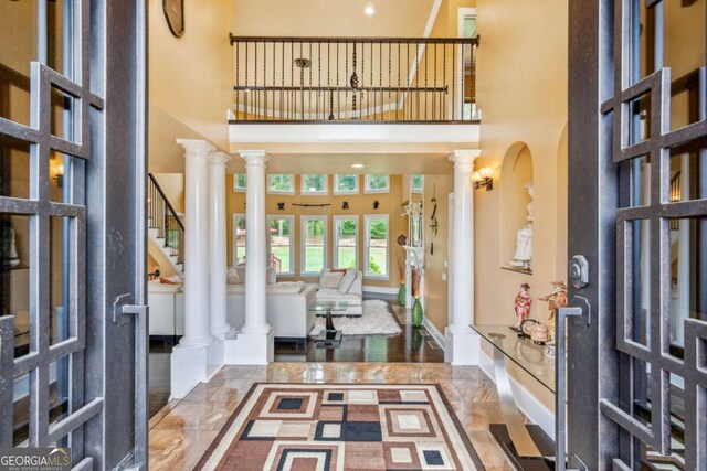 3364 Kylee Dawn Cir, Lawrenceville, GA 30045 - entrance foyer with marble finish floor, a towering ceiling, ornate columns, and stairs