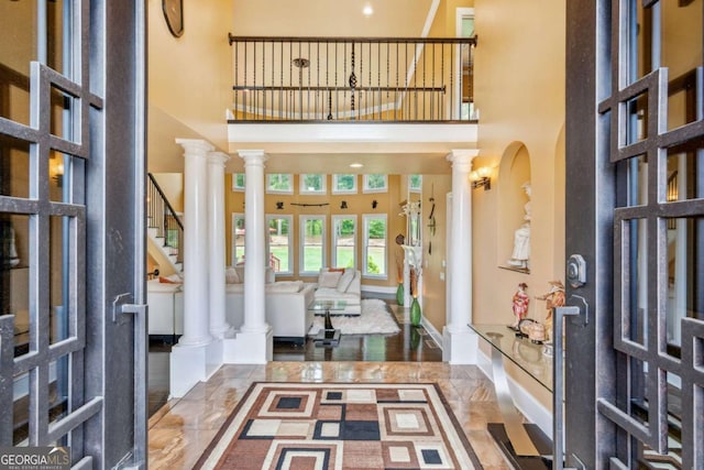 3364 Kylee Dawn Cir, Lawrenceville, GA 30045 - foyer entrance featuring ornate columns, a towering ceiling, marble tiled floors, and stairs