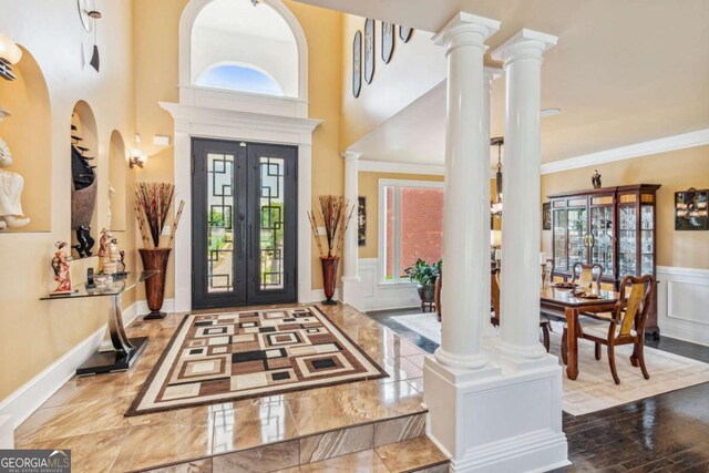 3364 Kylee Dawn Cir, Lawrenceville, GA 30045 - entrance foyer featuring a wainscoted wall, a decorative wall, and decorative columns