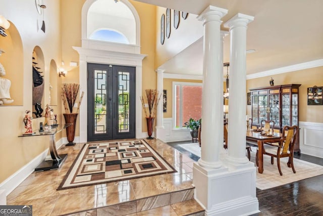 3364 Kylee Dawn Cir, Lawrenceville, GA 30045 - entryway with a decorative wall, ornate columns, a wainscoted wall, ornamental molding, and french doors
