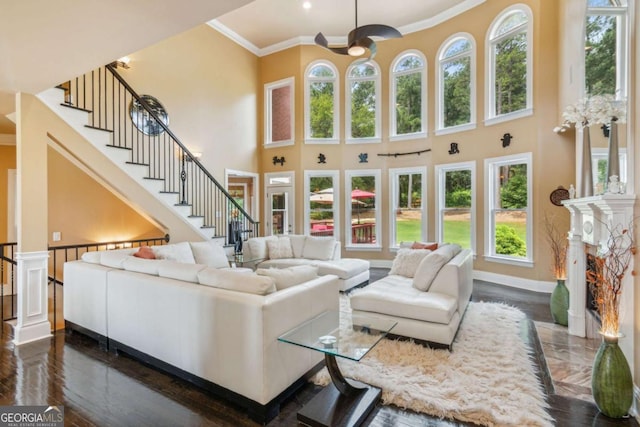 3364 Kylee Dawn Cir, Lawrenceville, GA 30045 - living area with dark wood-style floors, stairway, crown molding, and a towering ceiling