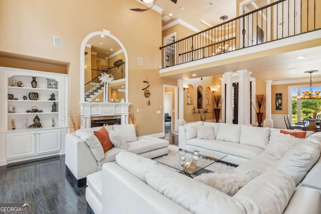 3364 Kylee Dawn Cir, Lawrenceville, GA 30045 - living area with ornamental molding, a towering ceiling, dark wood-style floors, arched walkways, and built in features