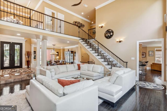 3364 Kylee Dawn Cir, Lawrenceville, GA 30045 - living room featuring crown molding, a towering ceiling, and ornate columns
