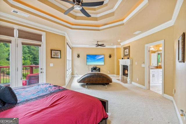 3364 Kylee Dawn Cir, Lawrenceville, GA 30045 - bedroom featuring crown molding, a tray ceiling, access to outside, a fireplace with flush hearth, and light carpet