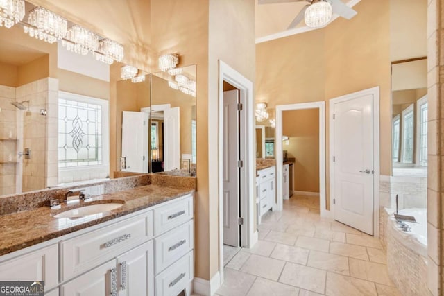 3364 Kylee Dawn Cir, Lawrenceville, GA 30045 - full bath featuring vanity, a high ceiling, tiled shower, a bath, and a chandelier