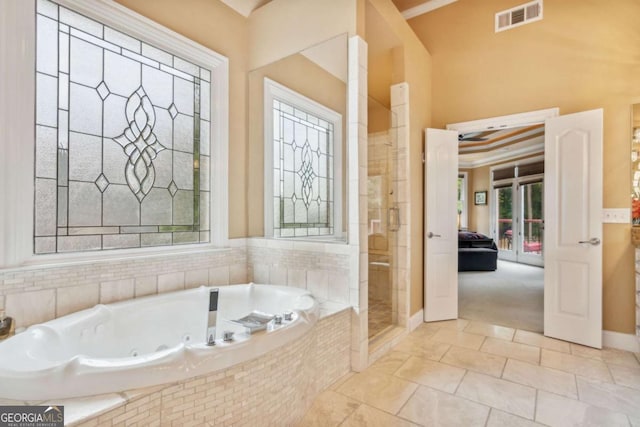 3364 Kylee Dawn Cir, Lawrenceville, GA 30045 - bathroom featuring a jetted tub, a shower with door, and tile patterned floors