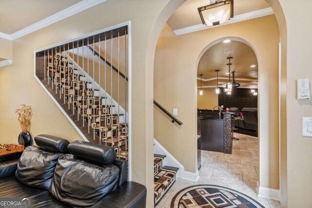 3364 Kylee Dawn Cir, Lawrenceville, GA 30045 - stairway with stone tile flooring, baseboards, ornamental molding, and arched walkways