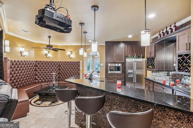3364 Kylee Dawn Cir, Lawrenceville, GA 30045 - kitchen with appliances with stainless steel finishes, open floor plan, crown molding, ceiling fan, and dark brown cabinetry