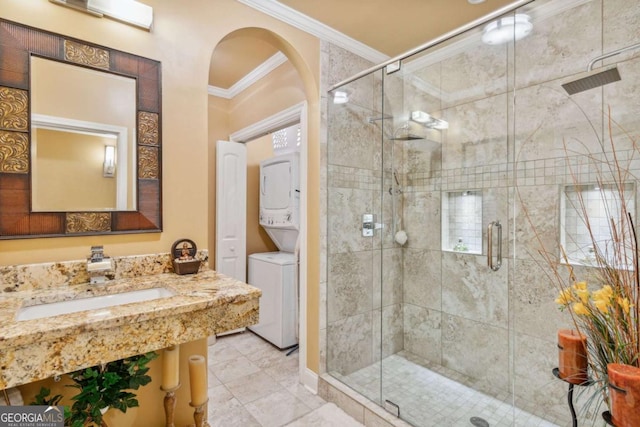 3364 Kylee Dawn Cir, Lawrenceville, GA 30045 - full bath with stacked washer and clothes dryer, crown molding, a shower stall, and vanity