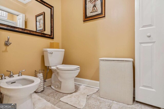 3364 Kylee Dawn Cir, Lawrenceville, GA 30045 - bathroom with toilet, a bidet, and baseboards
