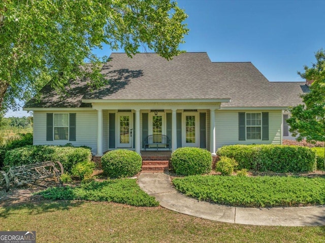 view of front facade with covered porch and roof with shingles