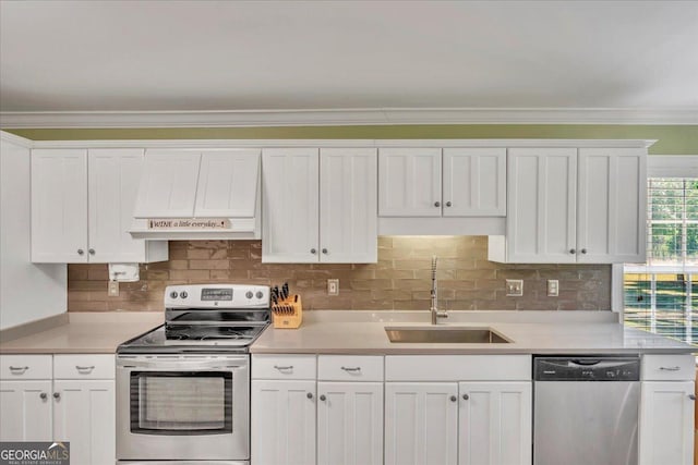 kitchen featuring a sink, stainless steel appliances, white cabinetry, and premium range hood