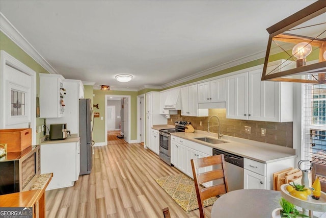 kitchen featuring a sink, stainless steel appliances, and white cabinets