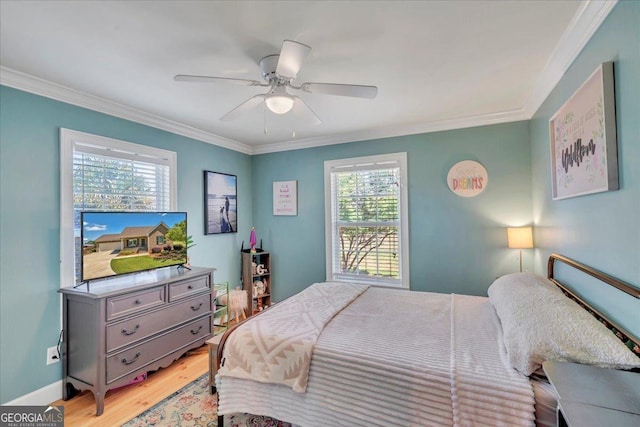 bedroom with crown molding, ceiling fan, and light wood-style floors