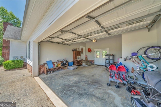 garage with french doors and a garage door opener
