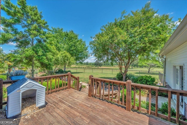 deck with a lawn and a fenced backyard