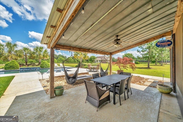 view of patio / terrace with outdoor dining area, an outdoor pool, and ceiling fan
