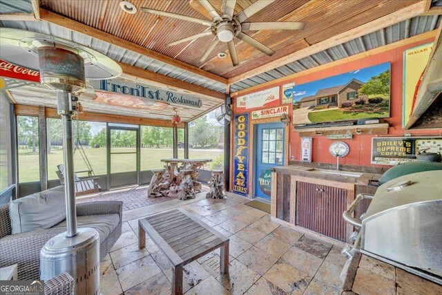 sunroom featuring a ceiling fan