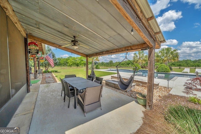 view of patio / terrace with an outdoor pool, a ceiling fan, and outdoor dining space