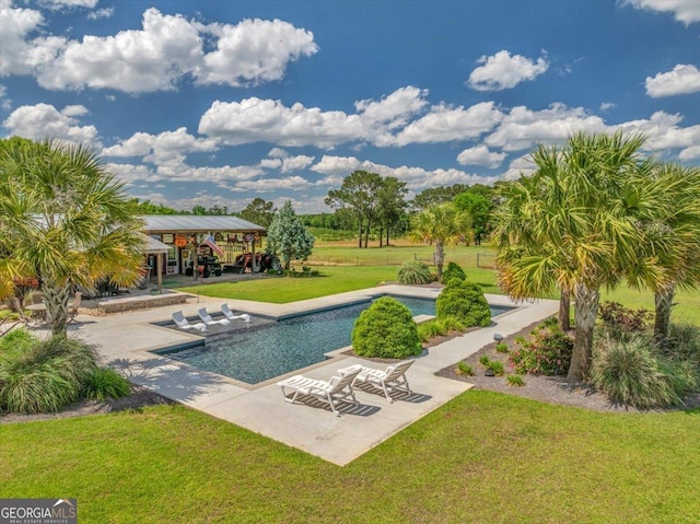 pool with a patio and a lawn