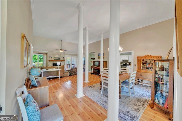living area with crown molding, ceiling fan, ornate columns, and wood finished floors