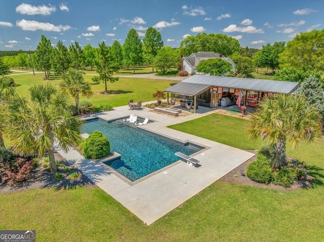 outdoor pool featuring a yard, a diving board, and a patio